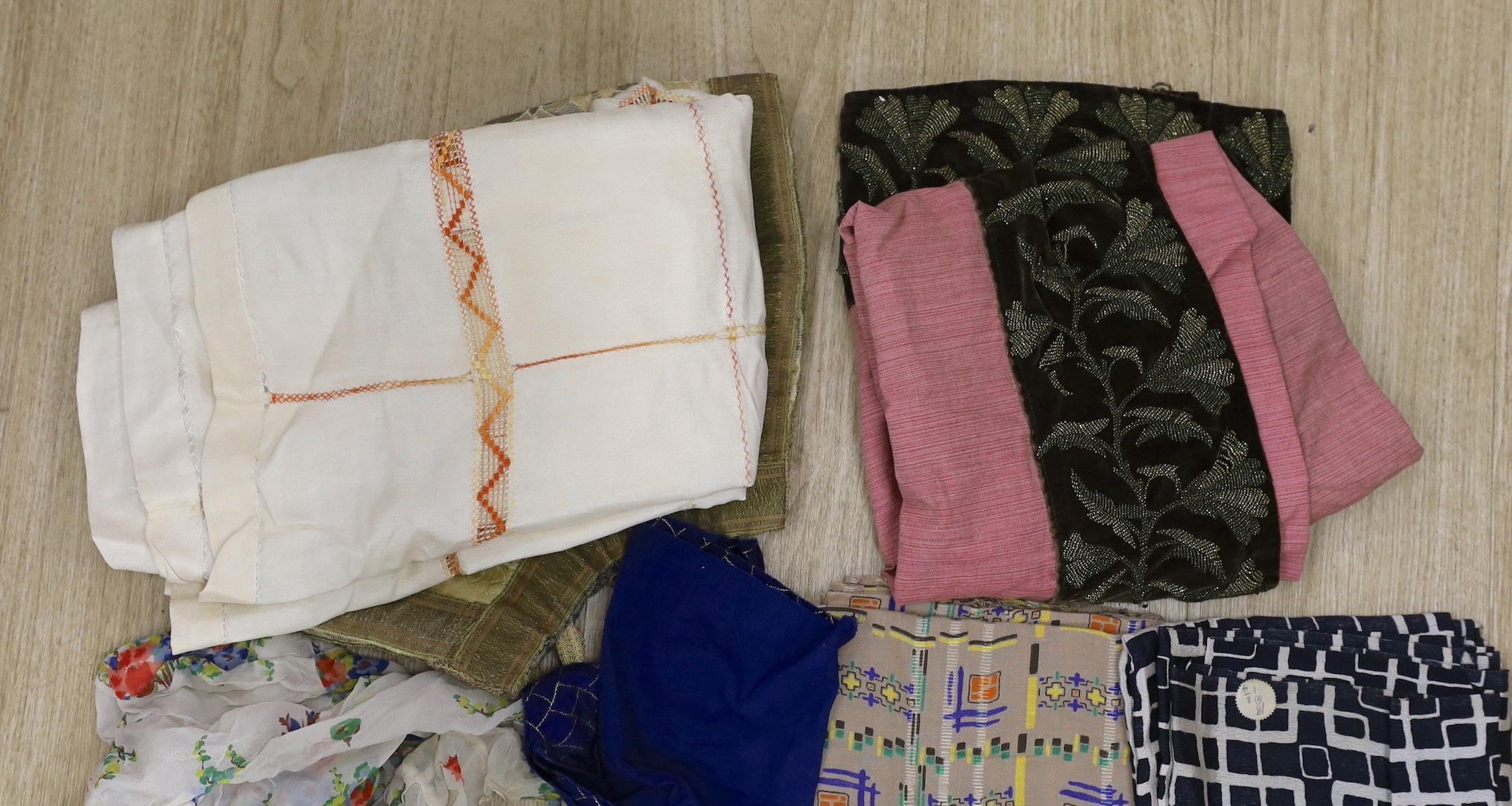 Various lengths of 1940's and later crepe, a large beaded edged cover and other fabrics, etc.